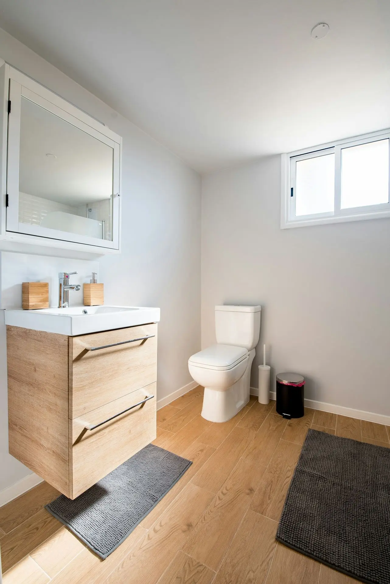 white ceramic toilet bowl near vanity combo