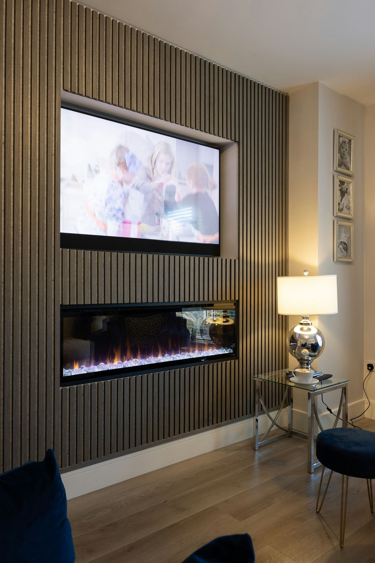 a living room with a fireplace and a flat screen tv