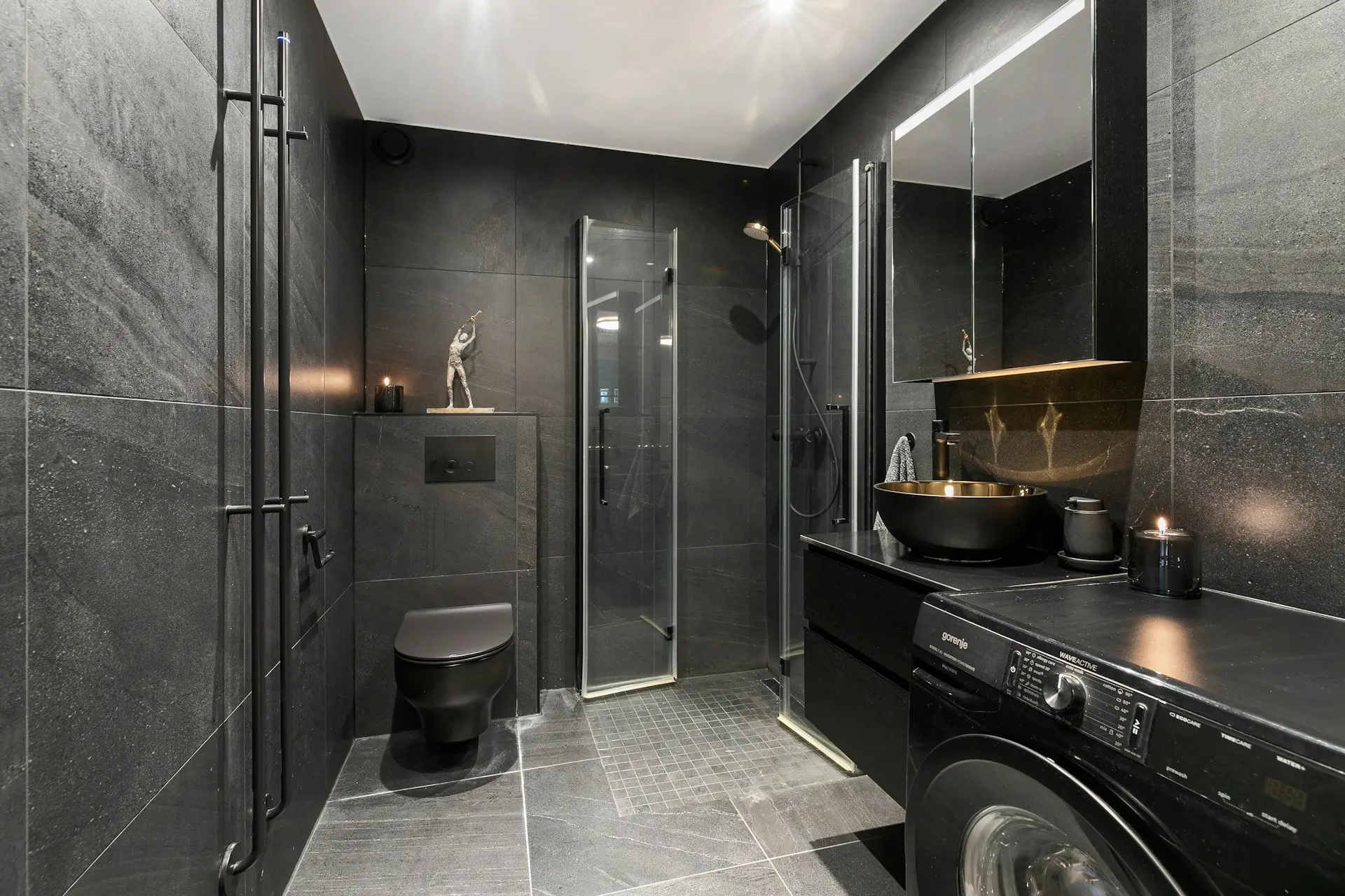 A washer and dryer in a bathroom with a skylight