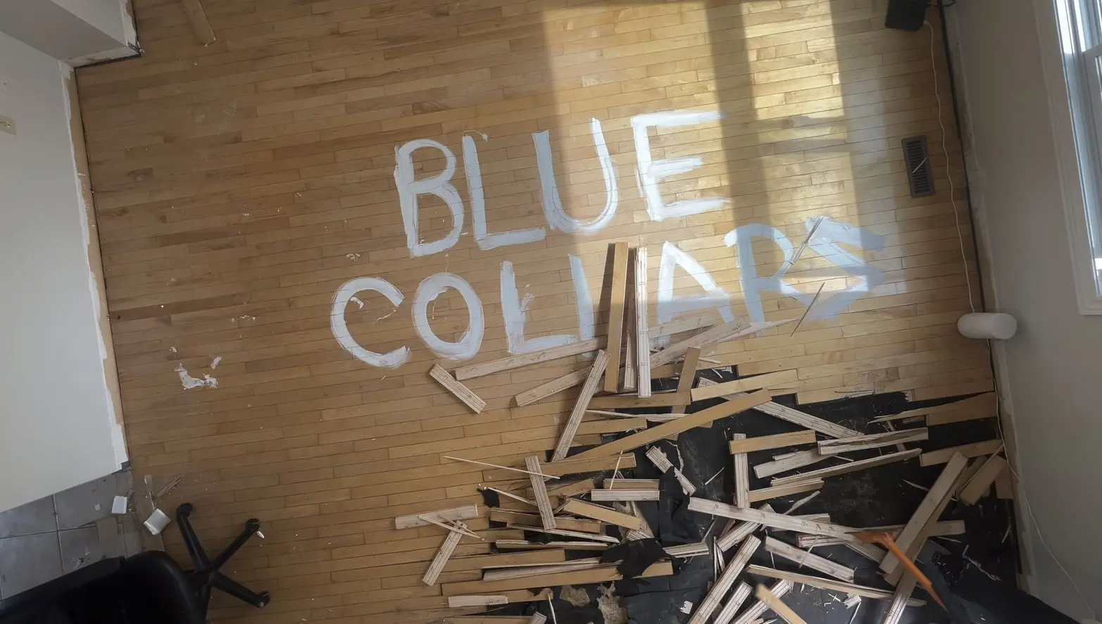 Old hardwood being removed by Blue collars in Brampton home